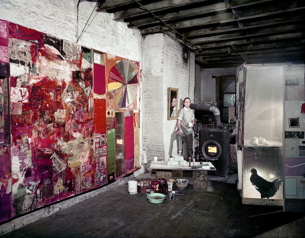 Rauschenberg in his Pearl Street studio, New York, March 1958. Works, left to right: Charlene (1954), Untitled (c. 1954), and a partial rear view of the second state of Monogram (1955–59, second state 1956–58). Photographer: Dan Budnik. Courtesy Robert Rauschenberg Foundation Archives, New York. © Dan Budnik<br/>